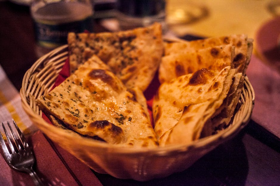 pexels-photo-1117862-1117862-2 Close-up of traditional Indian flatbreads in a basket, perfect for a delicious meal.