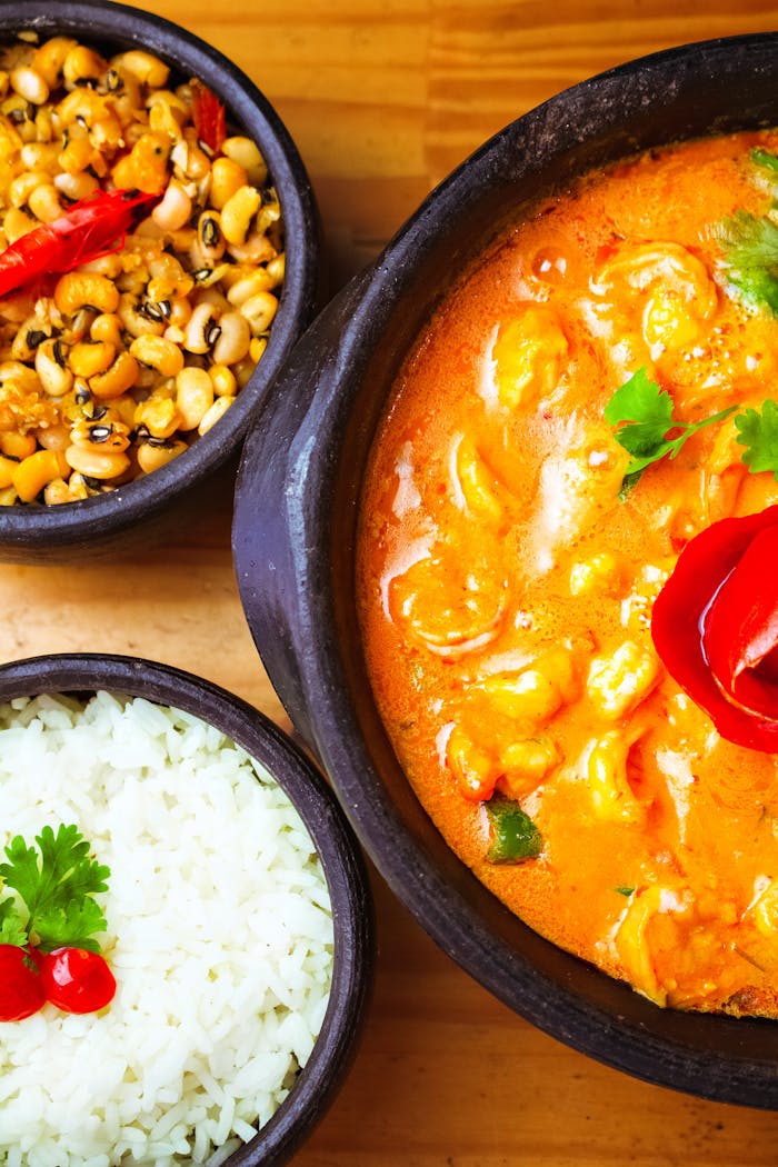 Vibrant Indian curry dish served with rice and beans, perfect for a hearty meal.